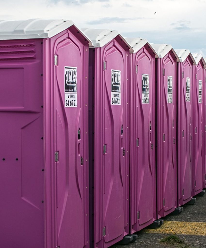 Pink portable toilets in a row.