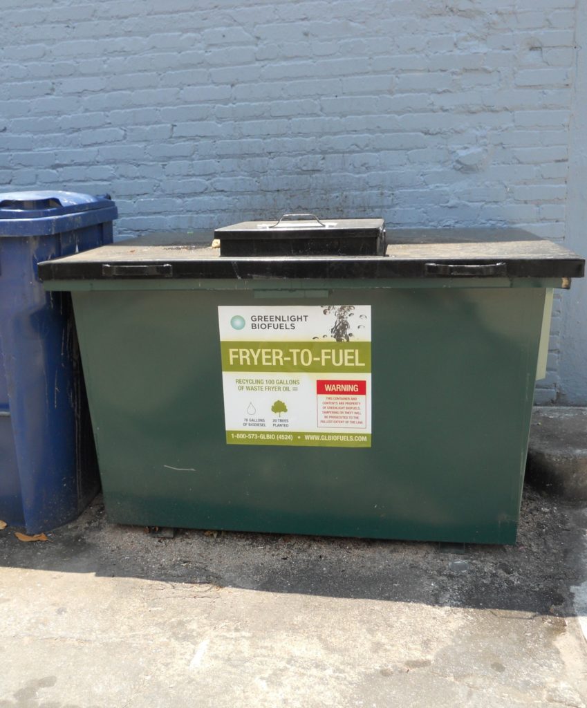 Green container for a collection of used oil.