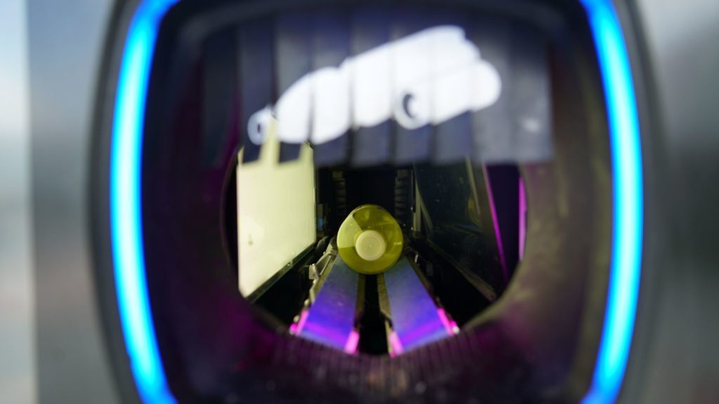 A plastic bottle inside of reverse vending machine.