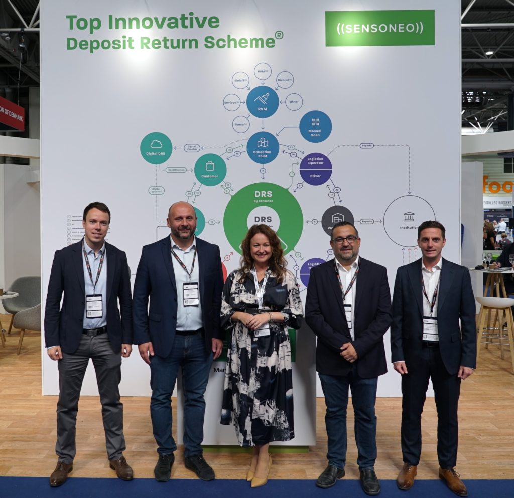 Representatives from Sensoneo, BCRS Malta and Spravca Zalohoveho System in front of the scheme of DRS at RWM exhibition.