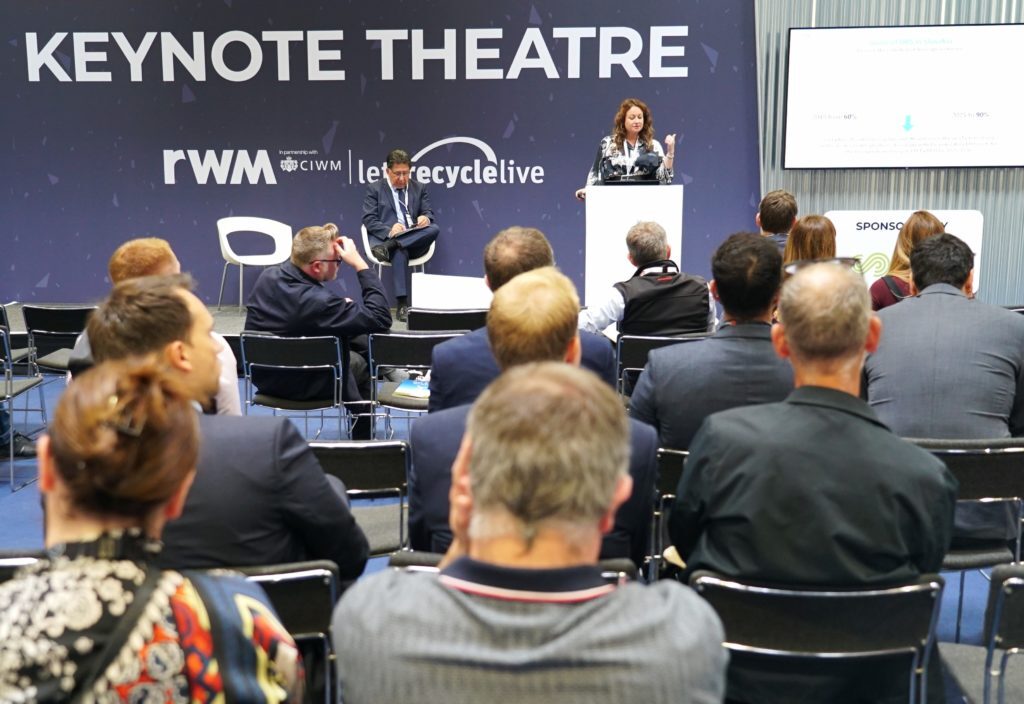 Lucia Morvai, the Director of External Affairs and Communications at the non-profit organization Deposit Return System Administrator, at the stage at RWM exhibition.