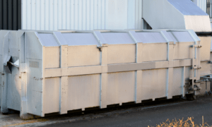 Couple of waste compactors next to each other.