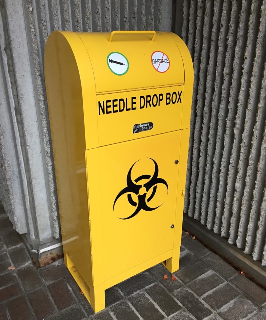 Yellow bin box for used sharps and needles.