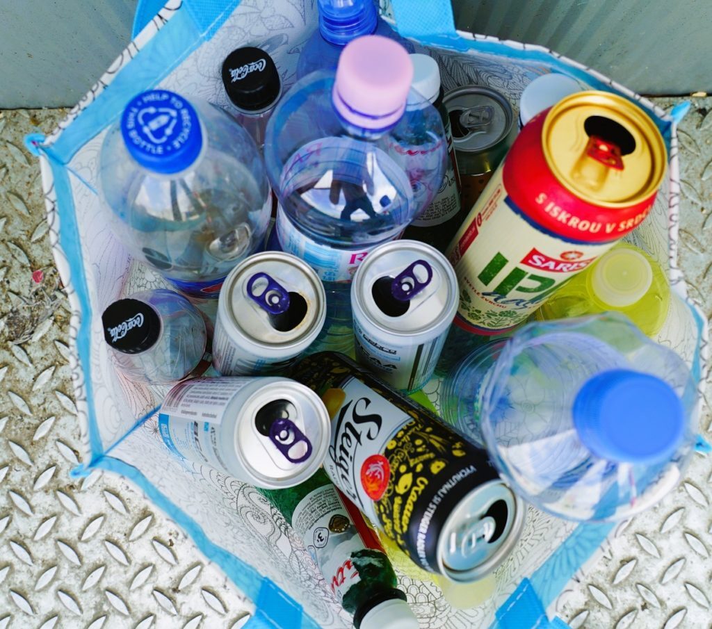 A bag with plastic bottles and aluminum cans. 