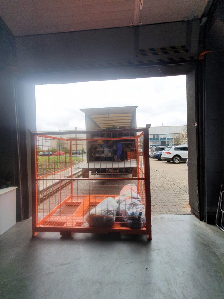 A truck filled with bags of used textile. 