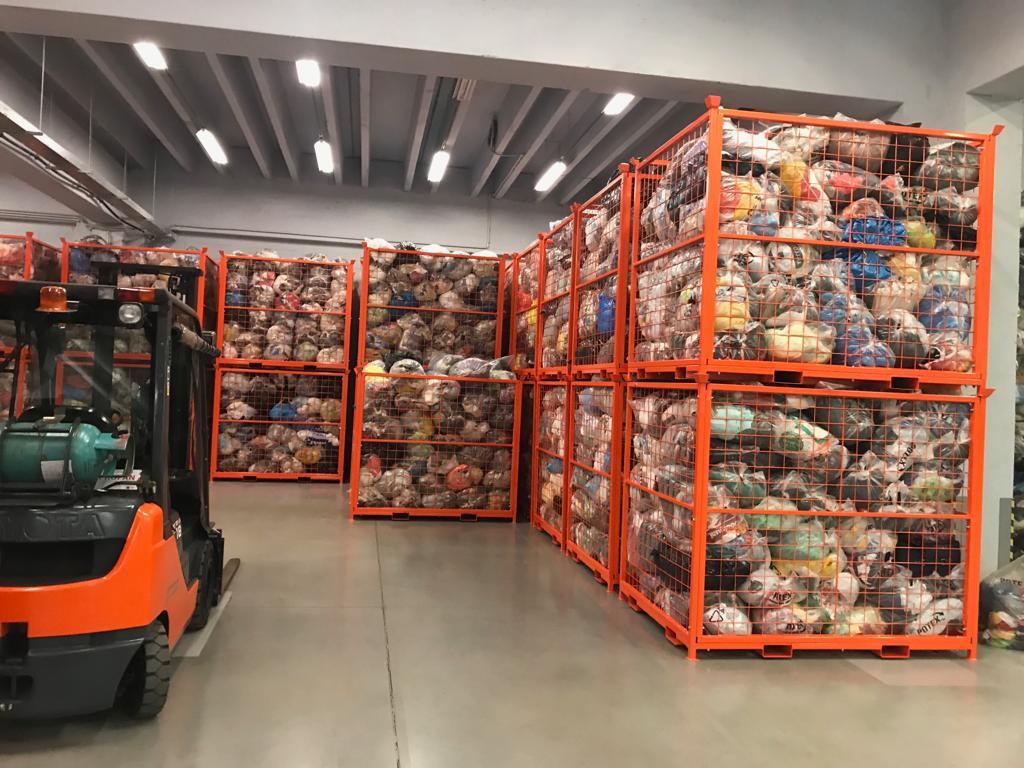 Textile containers from the Czech company Potex and their warehouse full of bags of old used clothes.