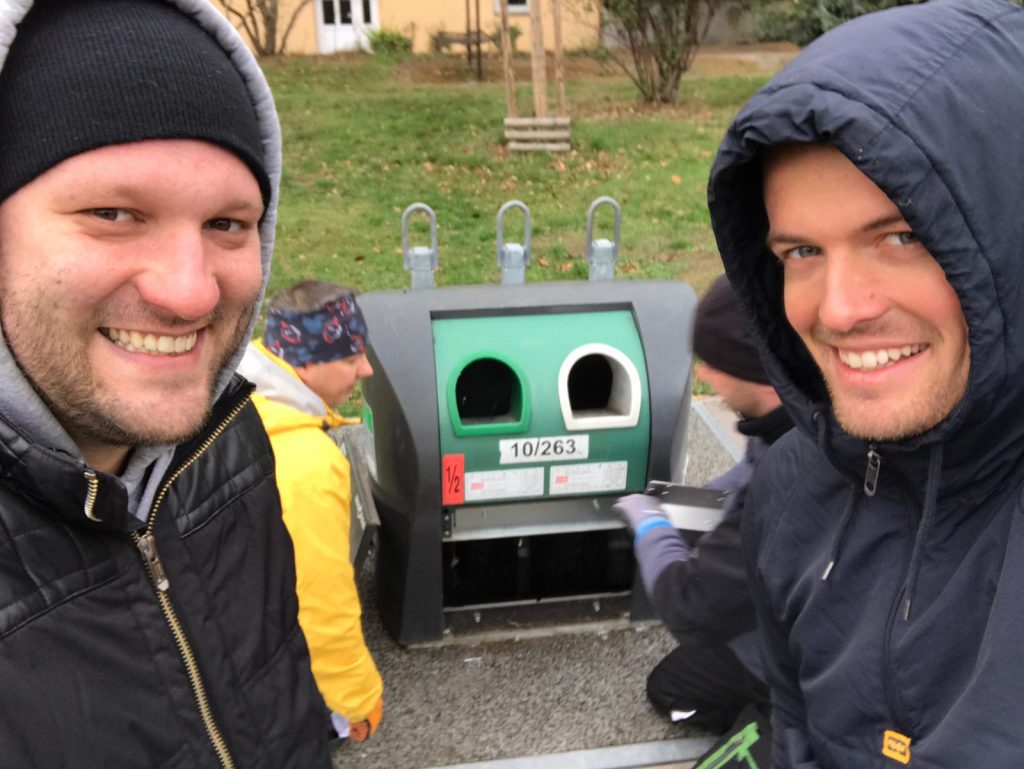 Technician guys installing sensors into underground bins in Prague.