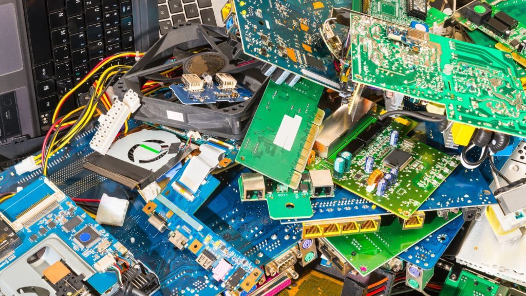 Different types of old used e-waste at junkyard.