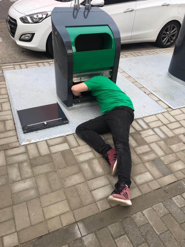 A technician installing sensor in the underground bins in Prague.